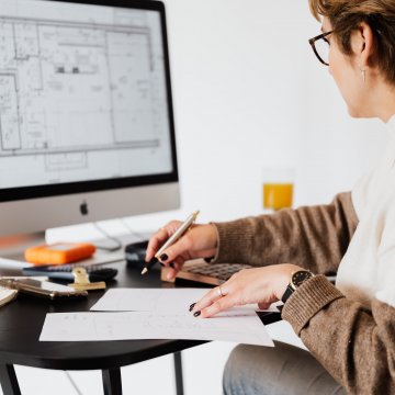 Woman designing blueprint